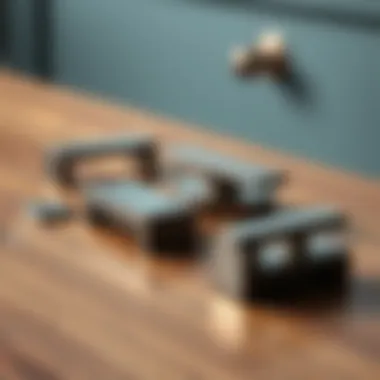 A set of modern metal drawer pulls displayed on a wooden surface